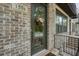 Charming front door with glass pane and wreath, set in a brick facade at 1598 Aldworth Se Pl, Marietta, GA 30067