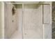 Walk-in shower with marble tile and glass doors at 1598 Aldworth Se Pl, Marietta, GA 30067