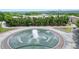 An attractive water fountain sits in front of upscale townhomes surrounded by mature shade trees and immaculate landscaping at 1598 Aldworth Se Pl, Marietta, GA 30067