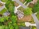 An aerial view showcases the house, highlighted by a pristine driveway and beautiful landscaping with mature trees at 1770 Laurel Creek Dr, Lawrenceville, GA 30043