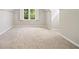 A finished attic space, carpeted with a large window, perfect for an extra living space at 1770 Laurel Creek Dr, Lawrenceville, GA 30043