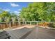 A spacious back deck with wooden floors and black metal railings offers beautiful views of the surrounding trees and greenery at 1770 Laurel Creek Dr, Lawrenceville, GA 30043