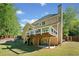 Spacious backyard with a deck, patio area, and mature trees at 1770 Laurel Creek Dr, Lawrenceville, GA 30043