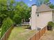 Backyard featuring a well-maintained lawn, framed by a wooden fence and mature trees offering privacy at 1770 Laurel Creek Dr, Lawrenceville, GA 30043