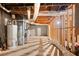 Unfinished basement with exposed beams, and mechanicals ready for customization at 1770 Laurel Creek Dr, Lawrenceville, GA 30043