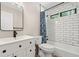 Modern bathroom with white subway tile, black hardware, and a stylish vanity and mirror at 1770 Laurel Creek Dr, Lawrenceville, GA 30043