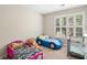 bedroom includes 2 beds and a window with plantation shutters providing natural light at 1770 Laurel Creek Dr, Lawrenceville, GA 30043