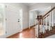 Inviting foyer featuring hardwood floors, a staircase with white railings, and natural light from sidelight windows at 1770 Laurel Creek Dr, Lawrenceville, GA 30043
