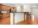 Charming kitchen boasts wood cabinets, granite countertops, and a breakfast bar with detailed woodwork at 1770 Laurel Creek Dr, Lawrenceville, GA 30043