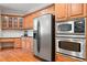Spacious kitchen features stainless steel appliances, wooden cabinetry, and a stylish subway tile backsplash at 1770 Laurel Creek Dr, Lawrenceville, GA 30043