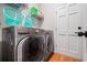 Practical laundry area with modern washer, dryer, and storage shelves, conveniently located at 1770 Laurel Creek Dr, Lawrenceville, GA 30043