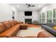 Inviting living room with a cozy fireplace, plush seating, and bright windows with plantation shutters at 1770 Laurel Creek Dr, Lawrenceville, GA 30043