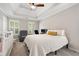 Serene main bedroom with tray ceiling, plush carpeting, and bright windows with plantation shutters at 1770 Laurel Creek Dr, Lawrenceville, GA 30043