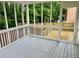 Covered screened back porch with grey floor looking to deck at 3045 Revere Cir, Snellville, GA 30039