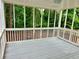 Covered screened back porch with grey floor at 3045 Revere Cir, Snellville, GA 30039