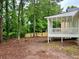 Backyard of home with covered screen porch, deck, and privacy fence at 3045 Revere Cir, Snellville, GA 30039