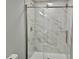 Bathroom featuring a glass enclosed shower with decorative marble style tiling at 3045 Revere Cir, Snellville, GA 30039