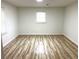 Light-filled bedroom with wood-look floors and neutral walls offers a serene atmosphere at 3045 Revere Cir, Snellville, GA 30039