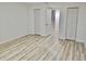 Clean bedroom featuring wood-look floors, white walls, and built-in closets with louvered doors at 3045 Revere Cir, Snellville, GA 30039