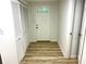 Bright entryway with wood-look flooring, closet, and a white front door with a window at 3045 Revere Cir, Snellville, GA 30039