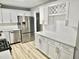 Modern kitchen with white cabinets, stainless steel appliances, quartz countertops, and luxury vinyl plank flooring at 3045 Revere Cir, Snellville, GA 30039