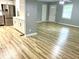 Inviting living area with bright vinyl plank flooring leading to the updated kitchen with white cabinets at 3045 Revere Cir, Snellville, GA 30039