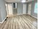 Open-concept living room features stylish flooring, neutral paint, and a ceiling fan at 3045 Revere Cir, Snellville, GA 30039