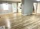 Open-concept living area with light gray walls and bright vinyl plank flooring leading to the updated kitchen at 3045 Revere Cir, Snellville, GA 30039