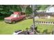 The backyard has a red truck with a basketball hoop and some farm equipment at 335 Chase Woods Cir, Jonesboro, GA 30236