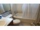 Bathroom with tiled walls, a bathtub with shower curtain, and a toilet at 335 Chase Woods Cir, Jonesboro, GA 30236