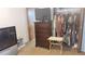 This bedroom has a TV on top of a dresser and an open closet to the right at 335 Chase Woods Cir, Jonesboro, GA 30236