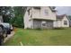 Side view of a home with siding and stone accents, adjacent to a driveway with multiple parked cars at 335 Chase Woods Cir, Jonesboro, GA 30236