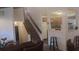 Spacious room featuring a staircase, view into kitchen and comfortable seating arrangement at 335 Chase Woods Cir, Jonesboro, GA 30236