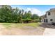 Large backyard area featuring a fenced border, mature trees, and a wooden deck at 11440 Azalea Trl, Hampton, GA 30228