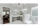 Spacious bathroom featuring double vanities, a large mirror, and glass enclosed shower at 11440 Azalea Trl, Hampton, GA 30228