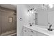 Elegant bathroom with double sinks, granite countertops, and a walk-in shower at 11440 Azalea Trl, Hampton, GA 30228