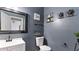 Stylish powder room featuring blue walls, modern fixtures, and decorative wall art at 11440 Azalea Trl, Hampton, GA 30228