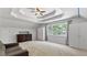 Bright room showcasing a tray ceiling, large window, and neutral carpeting at 11440 Azalea Trl, Hampton, GA 30228