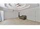 Large bedroom with neutral carpet features a tray ceiling and offers ample space at 11440 Azalea Trl, Hampton, GA 30228