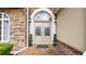 Elegant double front doors with decorative glass, stone accents, and manicured topiaries at 11440 Azalea Trl, Hampton, GA 30228