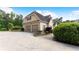 Spacious garage with parking for two cars, landscaping, and an extra exterior staircase at 11440 Azalea Trl, Hampton, GA 30228