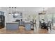 Open-concept kitchen with island, pendant lighting, and an adjacent dining area, perfect for entertaining at 11440 Azalea Trl, Hampton, GA 30228