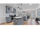 Stylish kitchen featuring gray cabinets, granite countertops, stainless steel appliances, and a functional island at 11440 Azalea Trl, Hampton, GA 30228