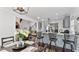 Bright kitchen with gray cabinets, granite countertops, and island with seating, flowing into the living area at 11440 Azalea Trl, Hampton, GA 30228