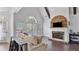 Bright living room with stone fireplace, hardwood floors, and large windows overlooking the backyard at 11440 Azalea Trl, Hampton, GA 30228