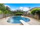 Inviting backyard pool with diving board surrounded by lush landscaping and a brick fence at 11440 Azalea Trl, Hampton, GA 30228