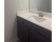 Bathroom vanity with dark cabinets, light countertop and sleek sink at 1155 Park Center Cir, Austell, GA 30168