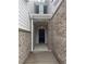Front door entrance with hanging light fixture in brick and grey siding entryway at 1155 Park Center Cir, Austell, GA 30168