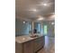 Open kitchen with a kitchen island, granite countertops and a view of the living room and backyard at 1155 Park Center Cir, Austell, GA 30168