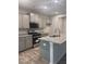 Modern kitchen features gray cabinets, granite countertops, stainless steel appliances, and a kitchen island at 1155 Park Center Cir, Austell, GA 30168